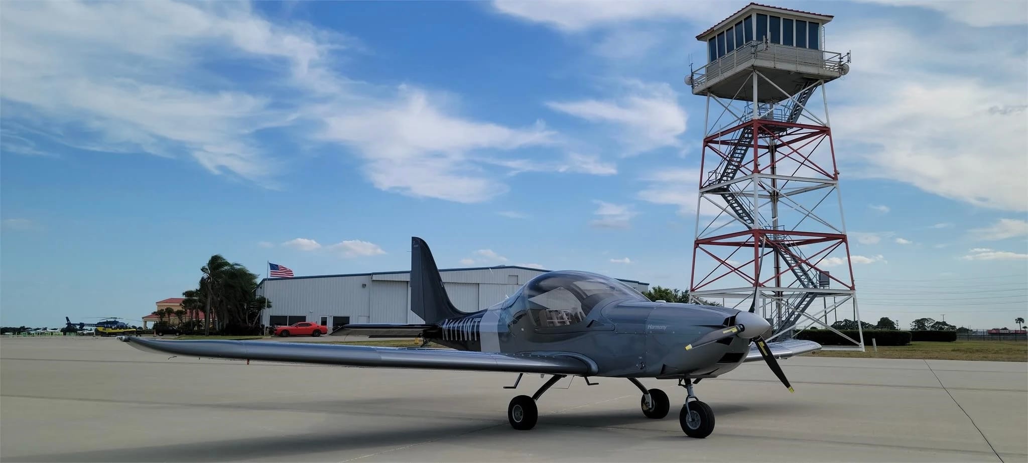 2024 Evektor Harmony LSA N111WT – left profile low angle, Sebring tower and American flag