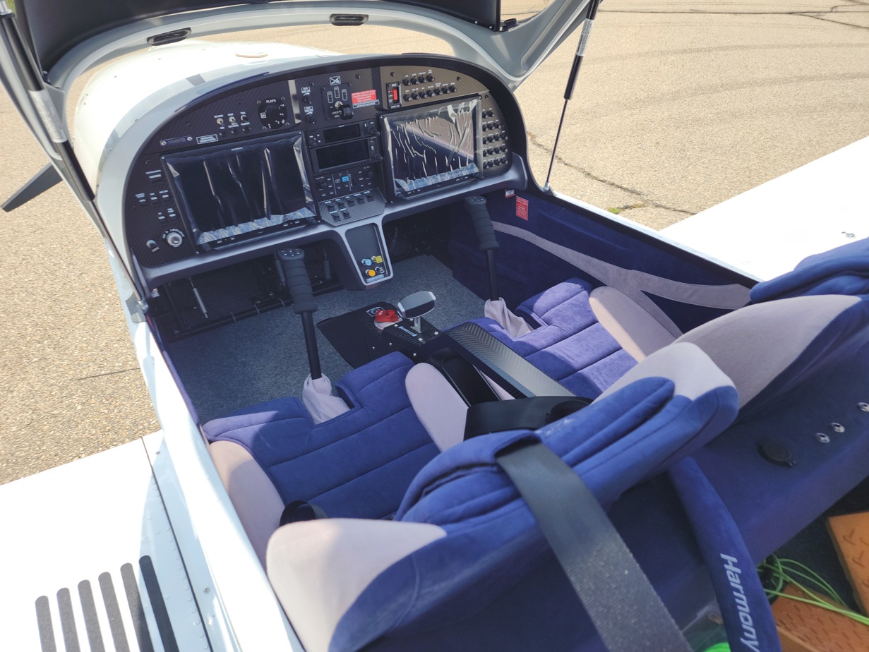 2024 Evektor Harmony cockpit interior showing avionics and blue seating